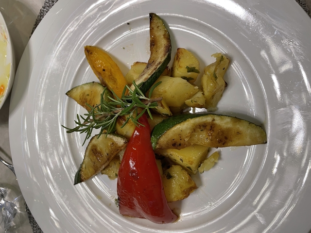 Plate of roasted vegetables with garnish.