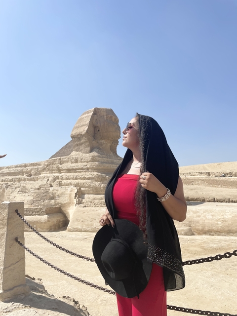       Person posing near Sphinx in Egypt.
  