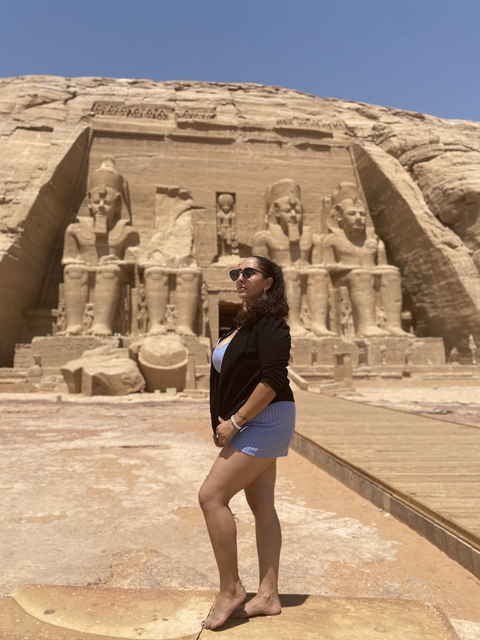       Person posing with figures in Abu Simbel, Egypt.
  
