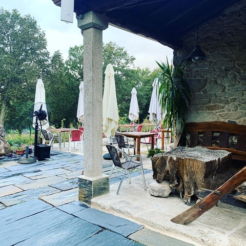 Outdoor dining area with tables and parasols.