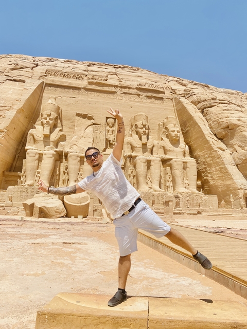       Man posing in front of the Abu Simbel temples.
  