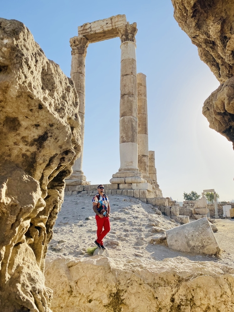       Columns and ruins with a man in the foreground.
  