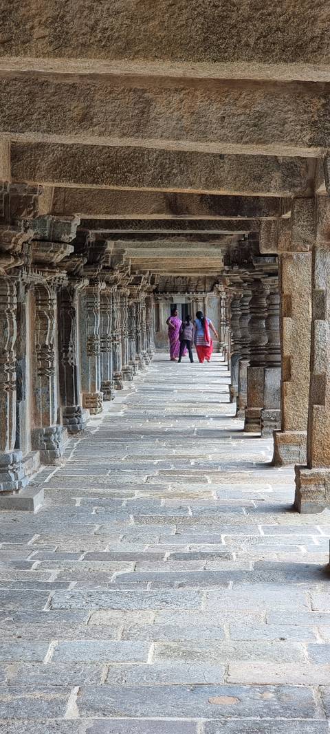       Interior view of a corridor with carved stone pillars.
  