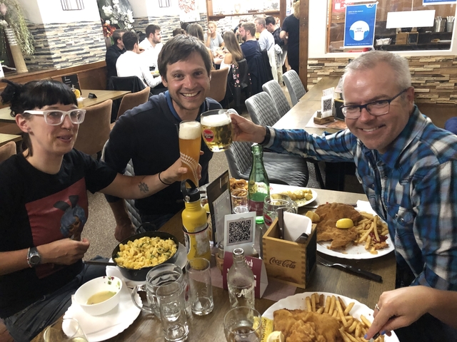 People enjoying a meal with drinks at a restaurant.