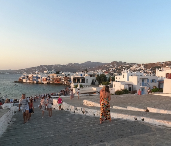 View of a coastal town with white buildings by the sea.