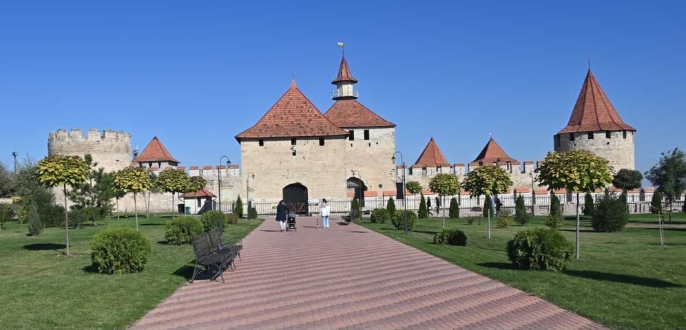       Fortress with red rooftops and wide pathways.
  