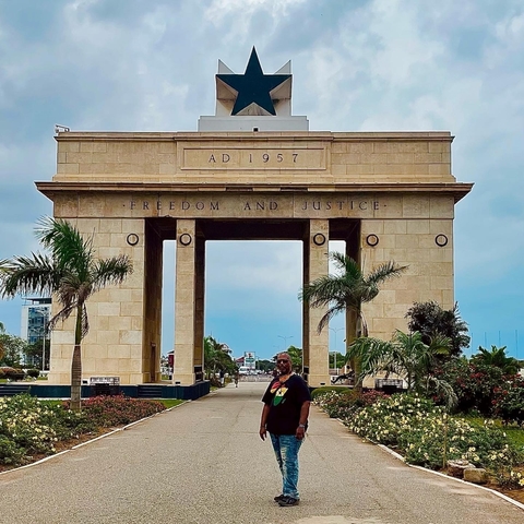       Independence Arch in Accra with a person in front.
  