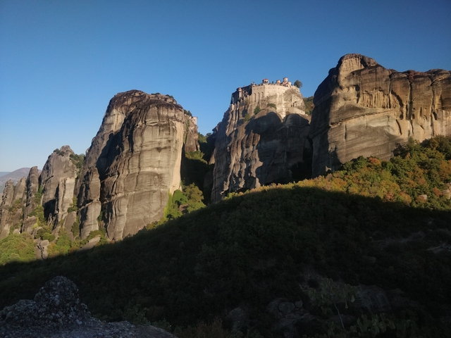 Towering rock formations with a monastery on top.
