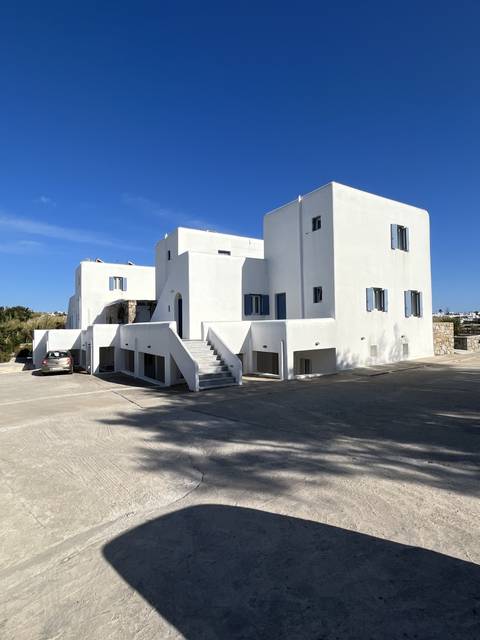       White buildings typical of Greek architecture against a blue sky
  