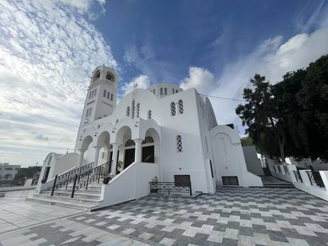       White church with arches and bell tower
  