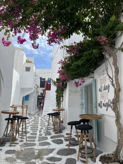       Picturesque alley in Mykonos with cafes and colorful flowers
  