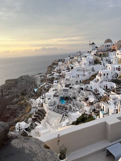       White houses and terraces on a steep hillside
  