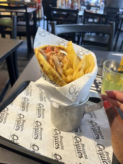       Plate of fries and a wrap in a restaurant setting
  