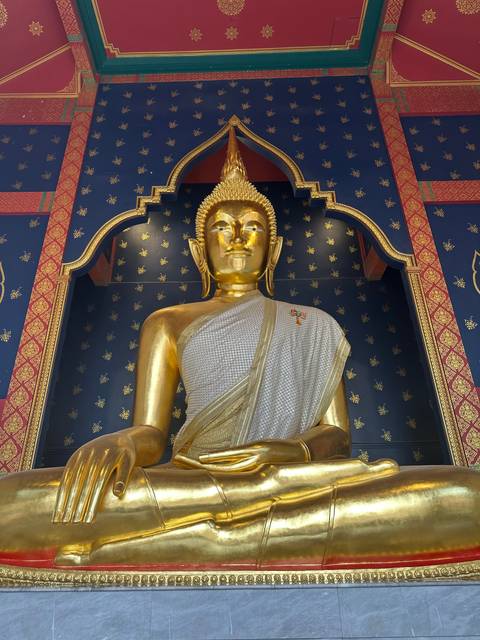       Golden Buddha statue in a temple.
  