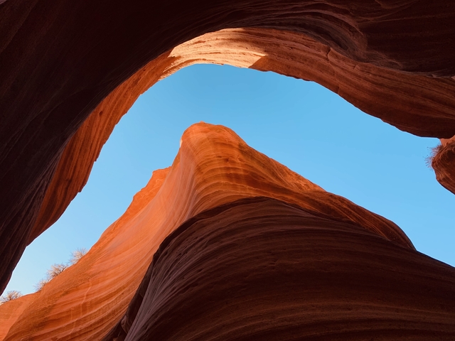 Tall canyon walls with blue sky above.