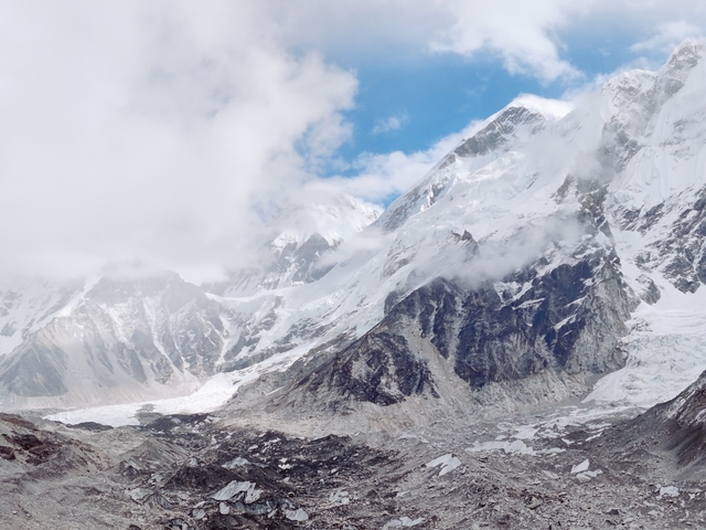       Snow-covered mountain peaks under a clear blue sky.
  