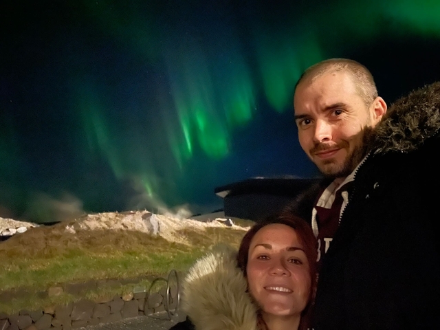 A couple with northern lights in the background