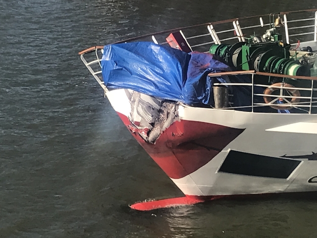       Boat with damage covered by tarps
  