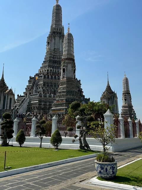       Temple with intricate detail and green lawns.
  