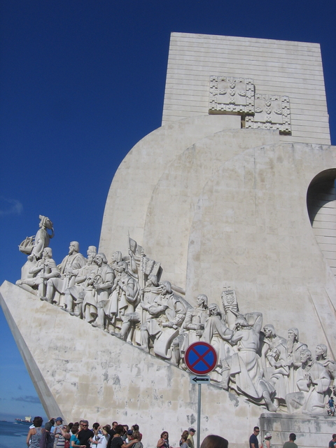 Monument with statues on a carved stone wall.