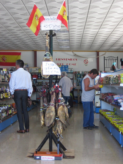 Inside a shop with a selection of jamon Iberico hanging.