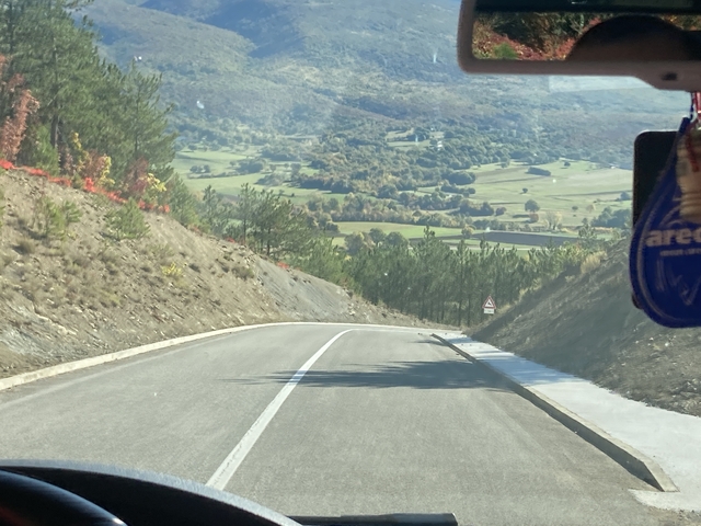       Scenic view of a road with a valley in the background.
  