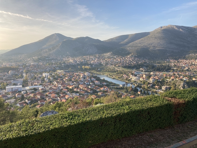       Aerial view of a city with mountains in the background.
  