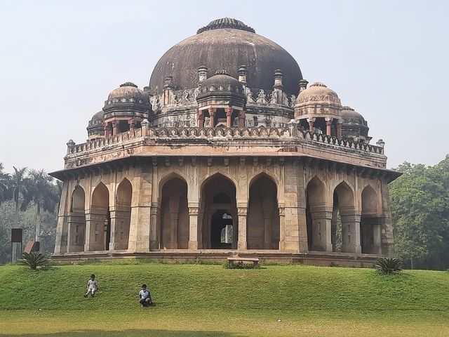 Lodhi Garden's tomb in New Delhi with children playing in front.