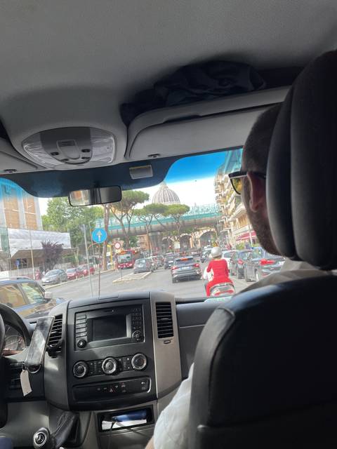       View from inside a vehicle looking onto city streets.
  