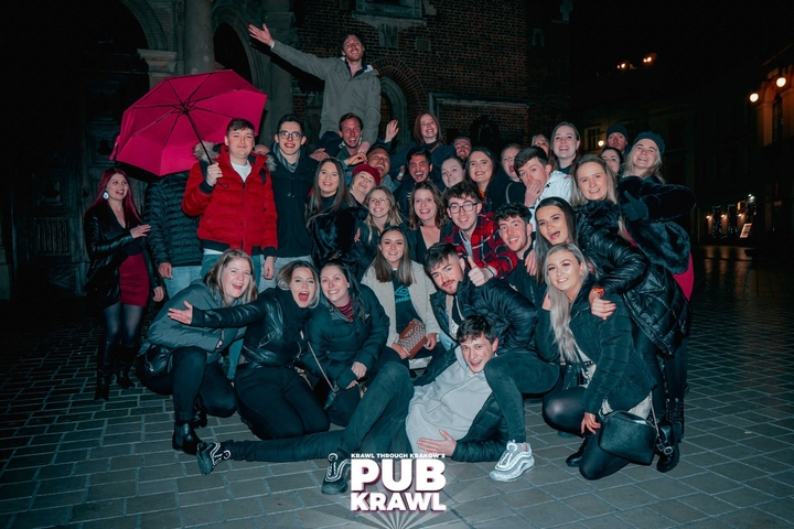 Group photo at night in the city with a large group of tourists.