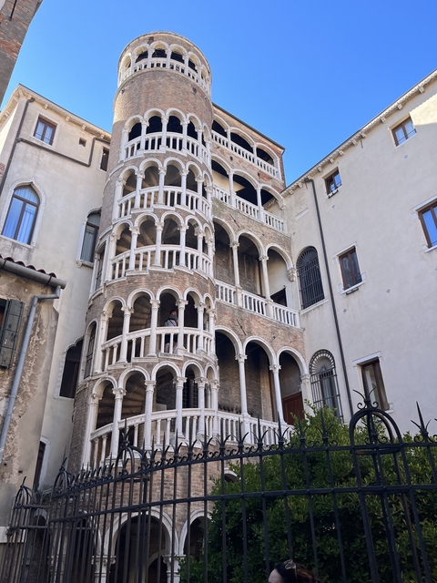 Spiral staircase on the facade of a historic building.