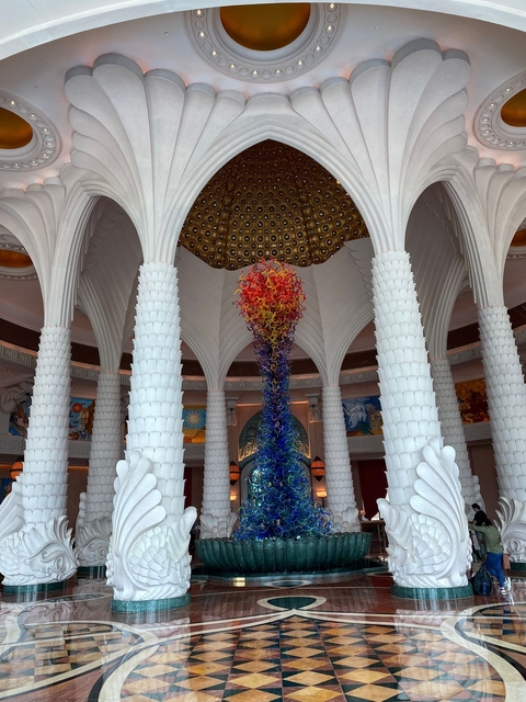Ornate indoor sculpture beneath a decorative ceiling.