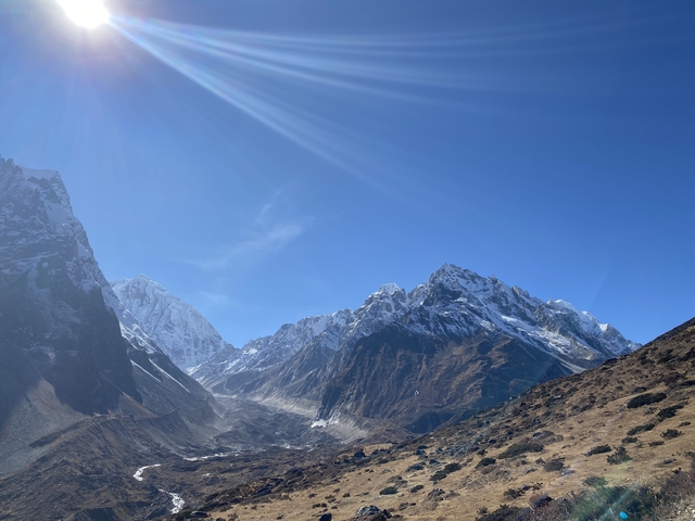       Snow-capped mountains under a clear blue sky.
  