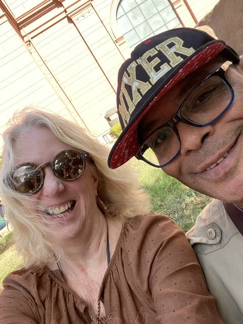 Close-up of two people smiling outside.