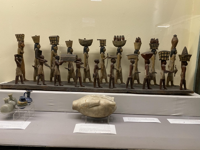 Ancient Egyptian figurines displayed in a museum.
