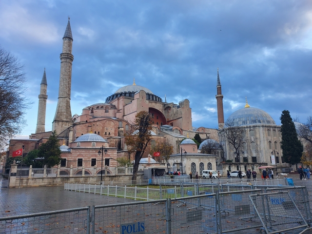      Close-up of the Hagia Sophia with people and flags.
  