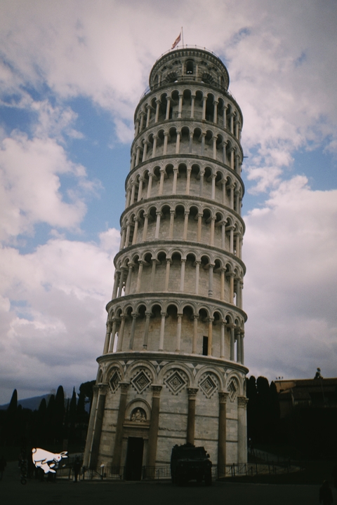       The Leaning Tower of Pisa against a blue sky.
  