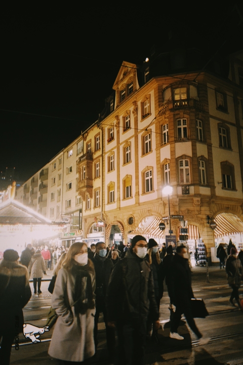       Street scene with illuminated buildings at night.
  