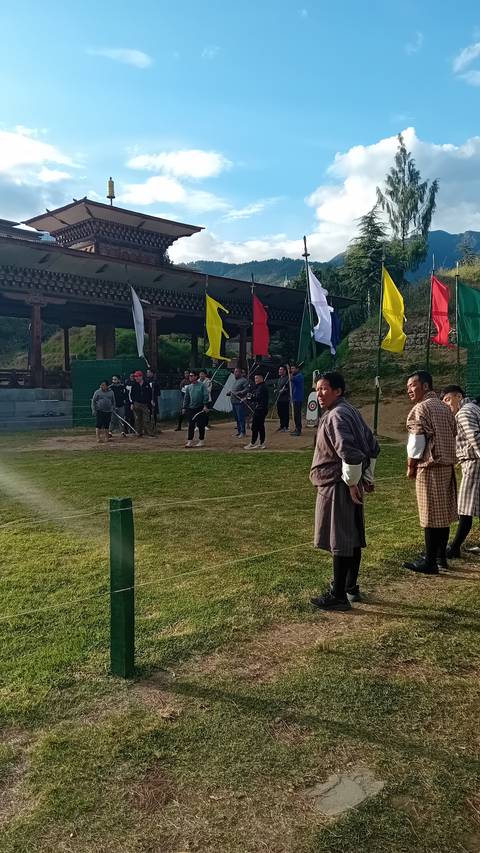       People in traditional dress participating in an outdoor festival.
  