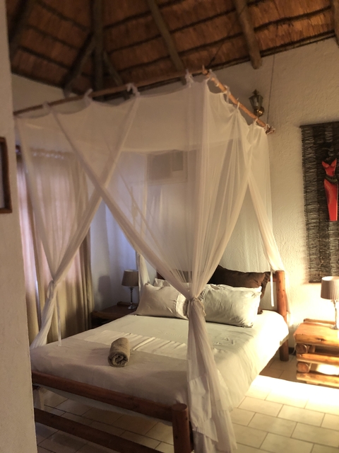 Interior of a bedroom with a canopy bed.