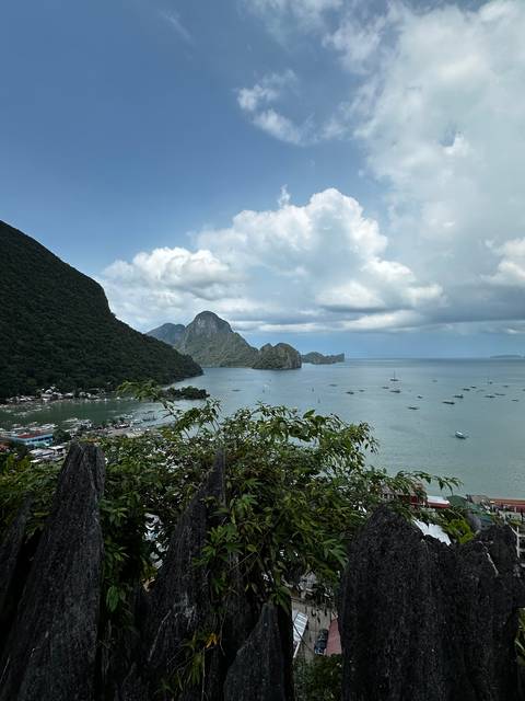 Aerial view of a bay with mountains and a clear blue sky.