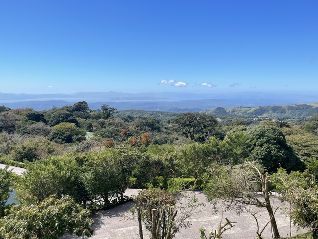       Scenic view of lush hills and distant mountains.
  