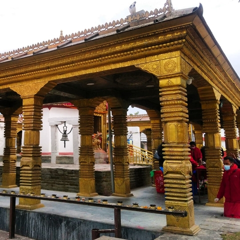       Golden detailed structure with people in the background.
  