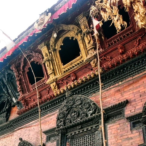       Intricately carved wooden facade of a building.
  
