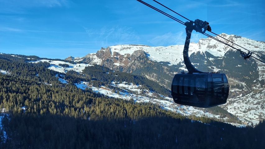 Snow-covered mountains with a cable car in the foreground