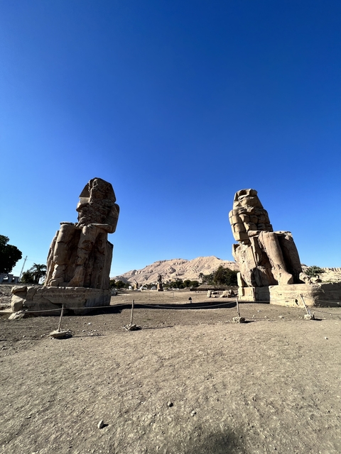Colossi of Memnon in a desert setting