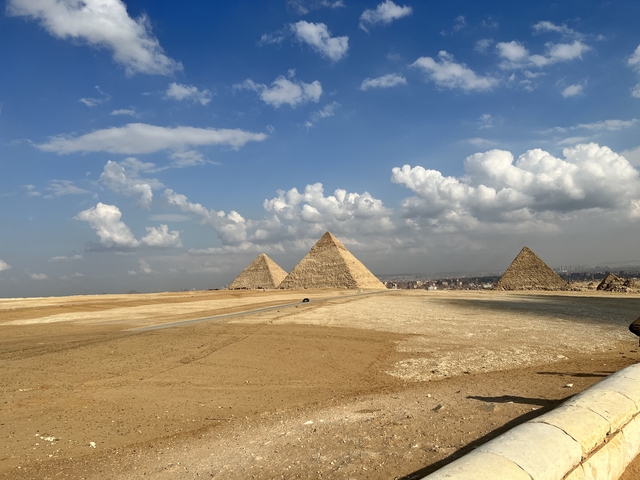 The Pyramids of Giza in a desert landscape.