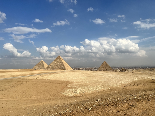 The Pyramids of Giza with a clear blue sky.
