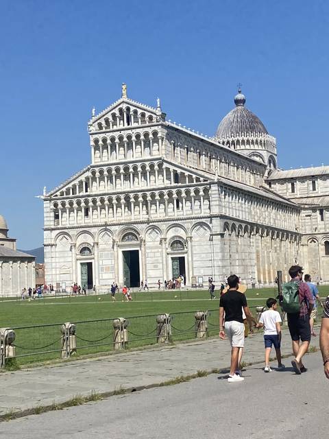      Tourists near a historical cathedral.
  