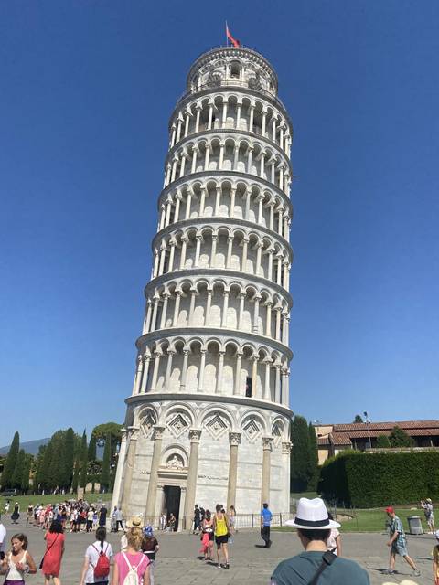      The Leaning Tower of Pisa with tourists around.
  